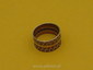 Punctured bronze ring